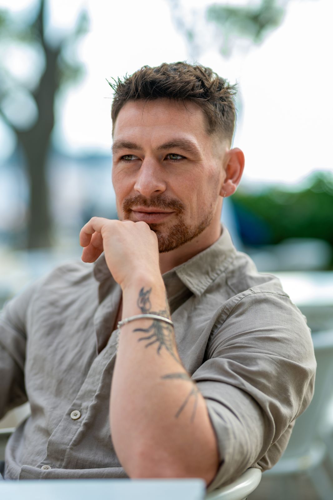Pensive man with tattoo in Lisbon. Portrait of a thoughtful man in Portugal. Lisbon vibes.