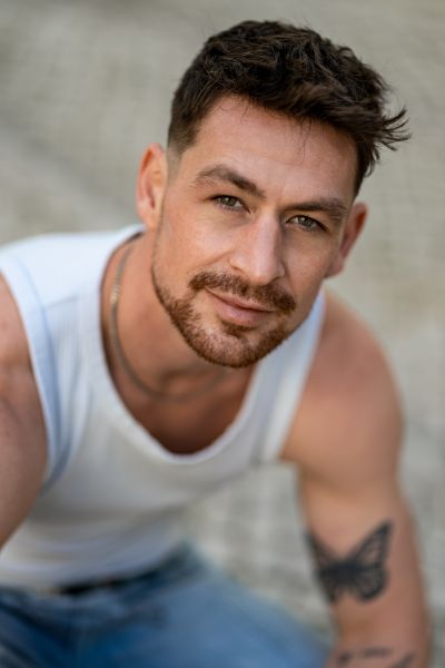 Handsome man with a butterfly tattoo in Lisbon, Portugal. Portrait. European model.