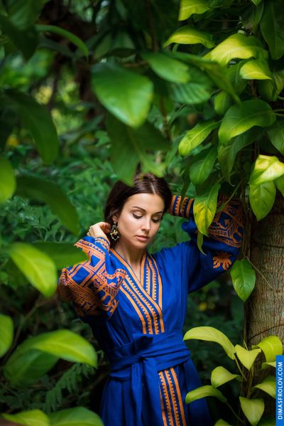 Woman in blue dress in Lisbon garden. Lush greenery, serene atmosphere. Lisbon, Portugal.