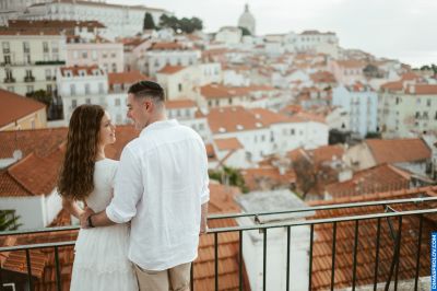 Couple embraces overlooking Lisbon-s rooftops. Romantic moment in Portugal-s historic city.