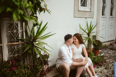 Couple in Lisbon, Portugal. Romantic moment by a traditional building with plants. Lisbon travel photography.