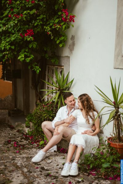Couple in Lisbon. Romantic moment on a charming street with flowers and plants. Portugal travel.