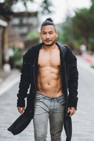 Stylish man in Lisbon. Open black jacket, grey jeans. Urban fashion, travel photography.